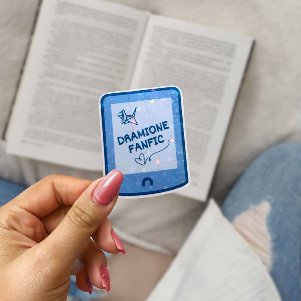 Book lover holding Dramione merch stickers with sparkly finish