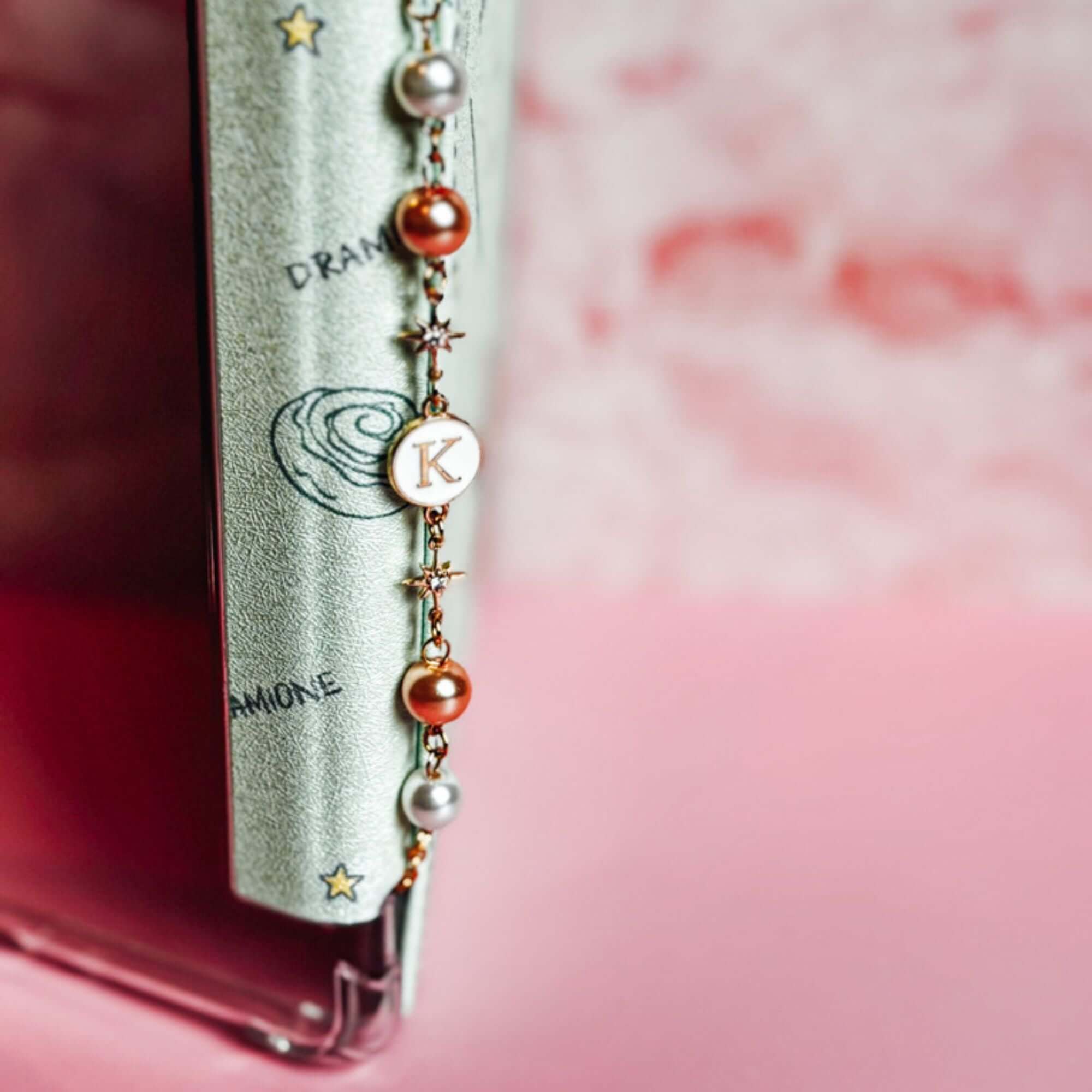 The perfect book lover’s accessory, combining classic pearls with a custom touch.