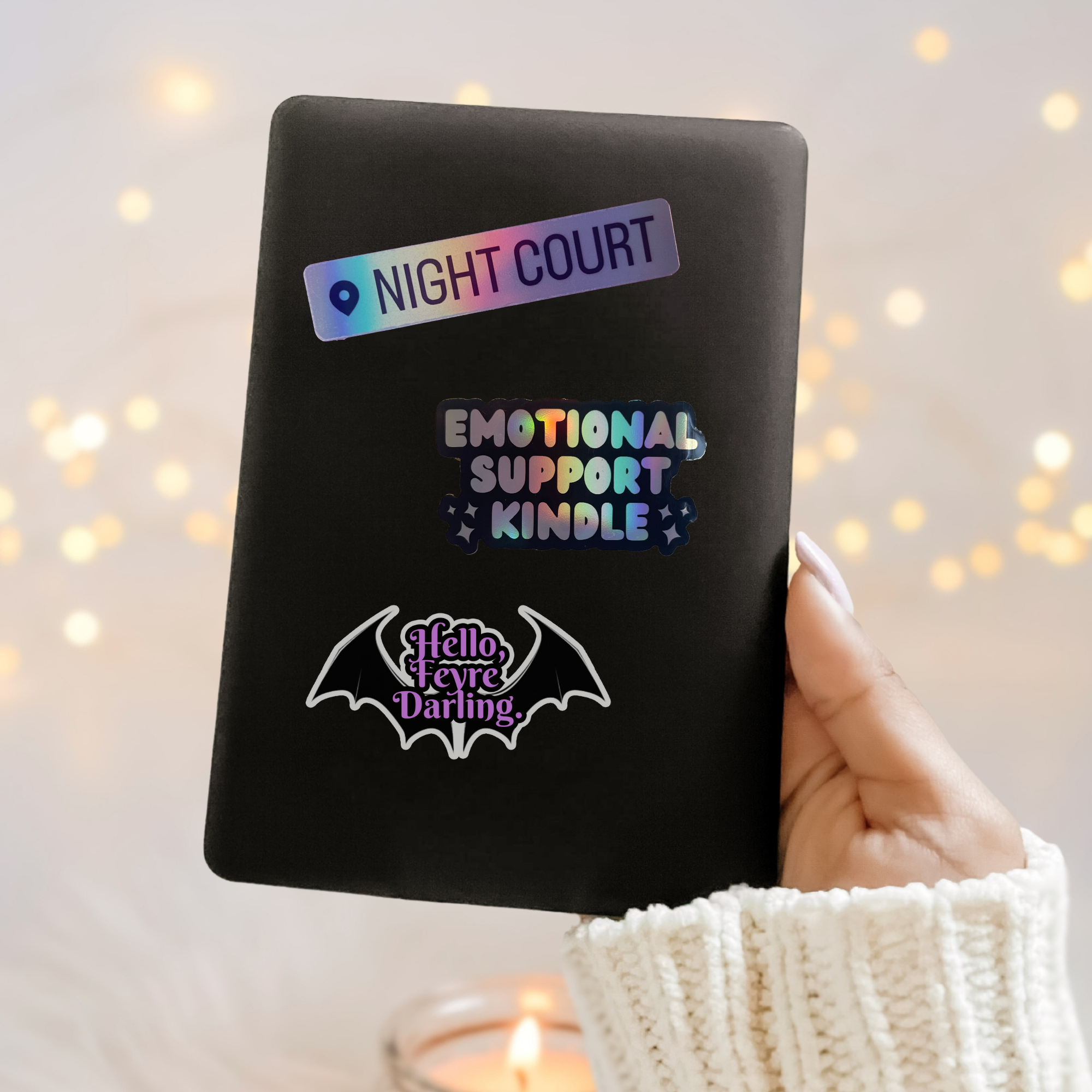 hand holding a kindle decorated with bookish stickers inspired by ACOTAR